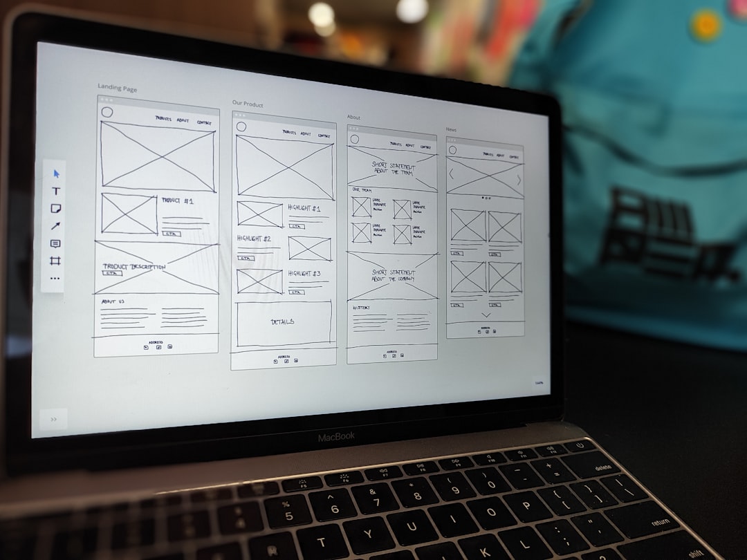 Laptop displaying a website wireframe for building profitable websites without coding in Nigeria