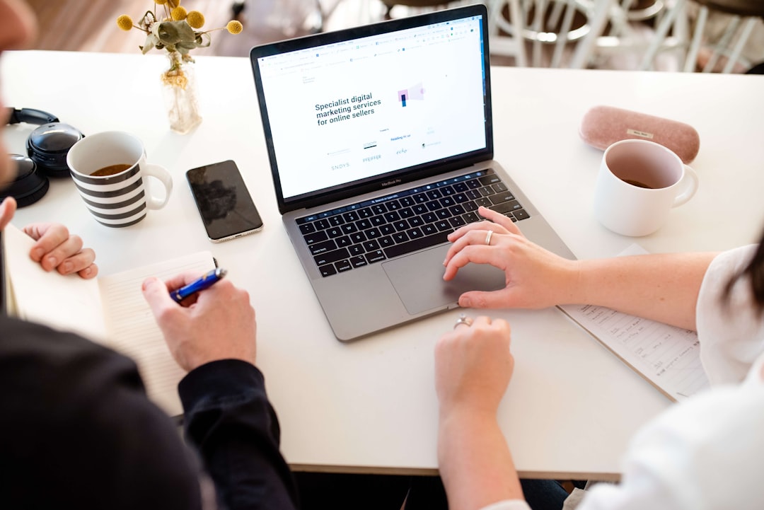 Business professionals comparing website platform options on a laptop