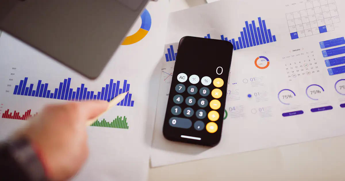 Calculator beside a laptop representing website costs in Nigeria in 2026