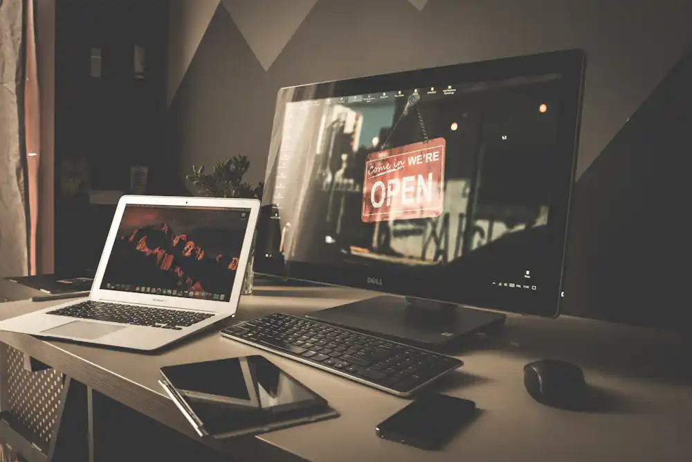 Laptop displaying a website portfolio in a freelance workspace