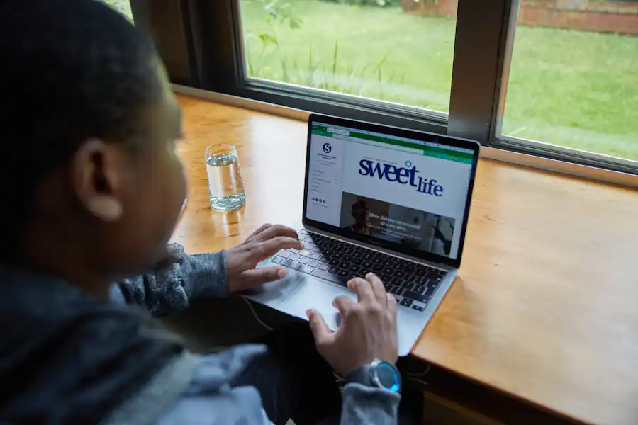 African web professional working on a laptop while maintaining client websites