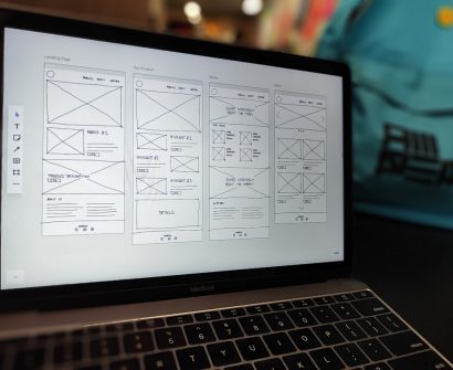 Laptop displaying a website wireframe for building profitable websites without coding in Nigeria