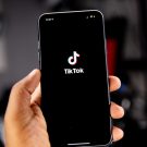 Person holding a smartphone with TikTok open for an advertising campaign