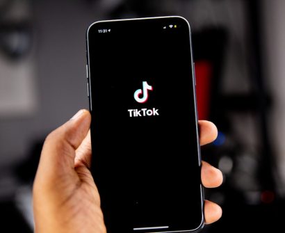 Person holding a smartphone with TikTok open for an advertising campaign