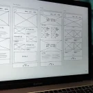 Laptop displaying a website wireframe for building profitable websites without coding in Nigeria
