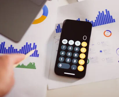 Calculator beside a laptop representing website costs in Nigeria in 2026
